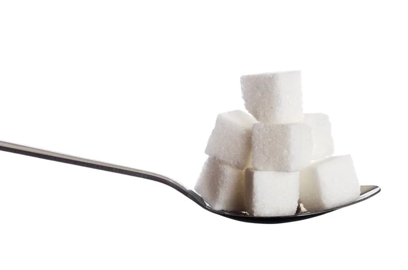 Sugar cubes and granulated sugar on a spoon