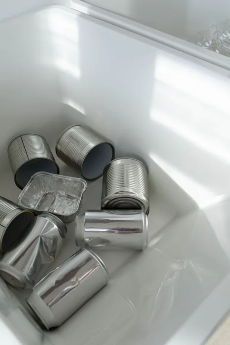 Empty aluminium beverage cans on a white surface